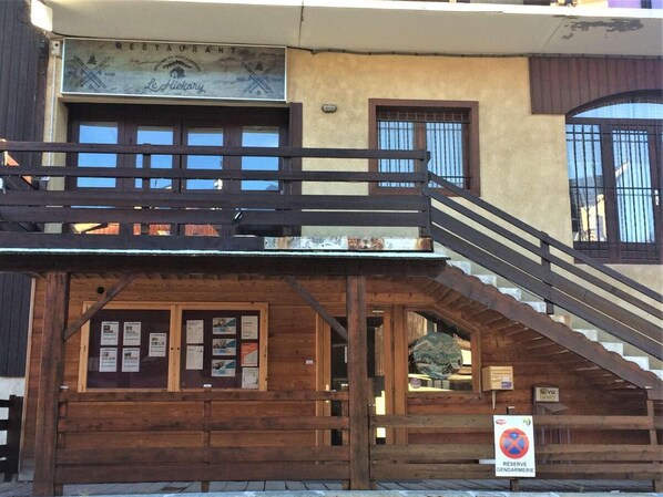 Experience the charm of a traditional restaurant with a balcony and staircase, offering a unique dining experience.