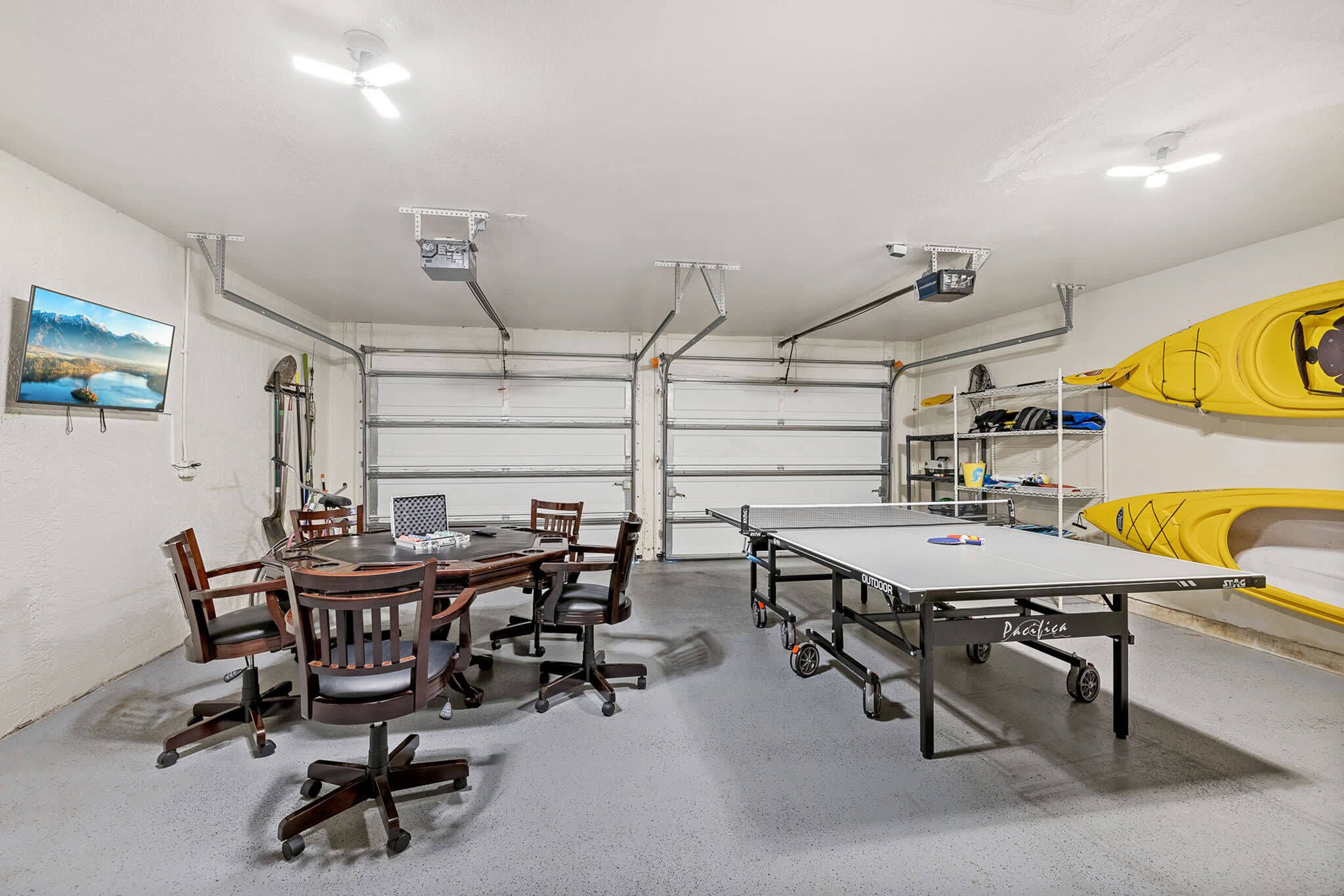 A conference room with a table, chairs, and a kayak in the background.