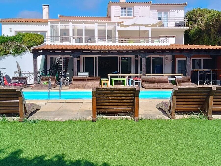 A two-story building with a swimming pool in front.