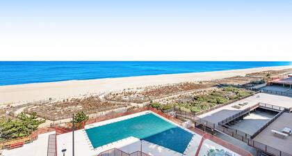 Oceanfront condo with beach access, pool, furnished balcony, & fast WiFi