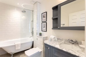 Bathtub, eco-friendly toiletries, hair dryer, towels