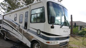 Een ruime camper met een gestroomlijnd design, een voorgril en een naamplaatje met de tekst 'Allegro Bay'.