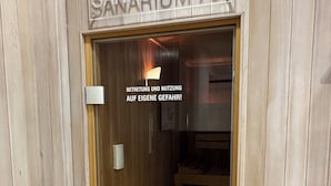 A wooden-paneled room with a sign reading "SANARIUM 70°". - Anna Düne 3-44 - Exclusive sea view at Aparthotel Anna Düne (Wangerooge)