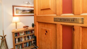 A wooden door with a brass plaque reading "ROTHAY 14".