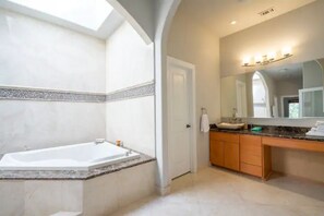 Bathtub, jetted tub, hair dryer, towels