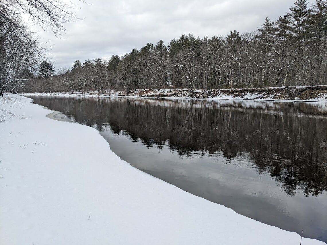 Private, snow covered Saco River shoreline on property.