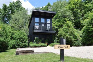 A modern black building with a sign reading 'Parker's Point.' - Parker's Point by Creative Cabins (Logan)