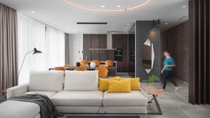 A modern living room with a sofa, a coffee table, and a dining area in the background. - Luxury 5-Star Spa Villa for Up to 12 Guests (Bale)