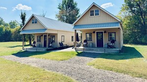 A two-story house with a porch and a welcome sign.