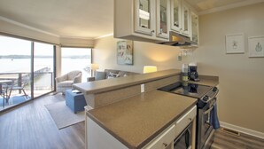 A modern kitchen with a large island, built-in cabinets, and a view of the water. - Sweet Lake Get Away (#2) in the Heart of Hot Springs (Hot Springs)