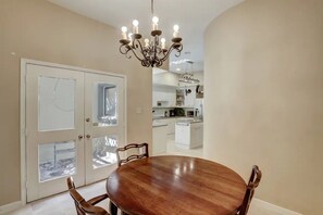 Enjoy meals in this cozy dining area with a round table and four chairs, offering a view of the surrounding landscape.