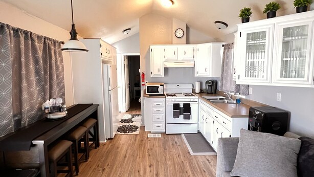 A compact living space with a kitchenette, a dining area, and a seating area.