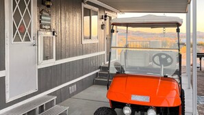 A covered outdoor area with a vehicle parked in front.