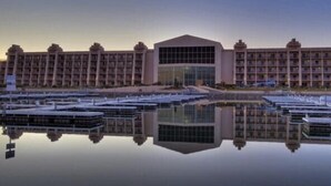 A large hotel with a central glass facade and multiple balconies. - Colorado River Retreat w/ RV spot  (Big River)
