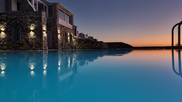 A stone building with a pool reflecting the sunset. - WhiteStone Villa Mykonos with private pool (mykonos)