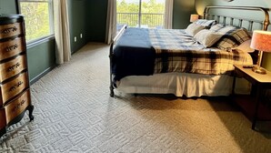 A bedroom with a wooden ceiling, a bed with a plaid bedspread, a dresser, and a window with curtains. - Murphy Sunset View--Perfect Getaway Location!! (Murphy)