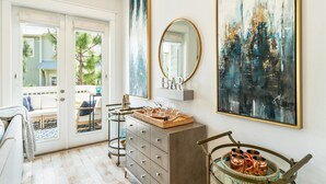 A modern bathroom with a large mirror, a wooden cabinet, and a decorative tray. - 30A Top Rated! Free Golf Cart+Bikes+2 Pools+Bunks (Inlet Beach)