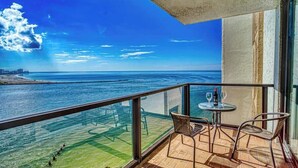 A balcony with a clear view of the sea and a distant shoreline. - Gorgeous 2/2 condo with fantastic views 1402 (Clearwater)