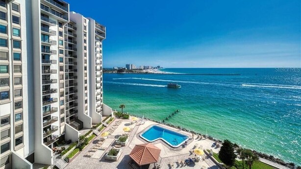 A high-rise hotel with a pool area and a view of the ocean. - Gorgeous 2/2 condo with fantastic views 1402 (Clearwater)