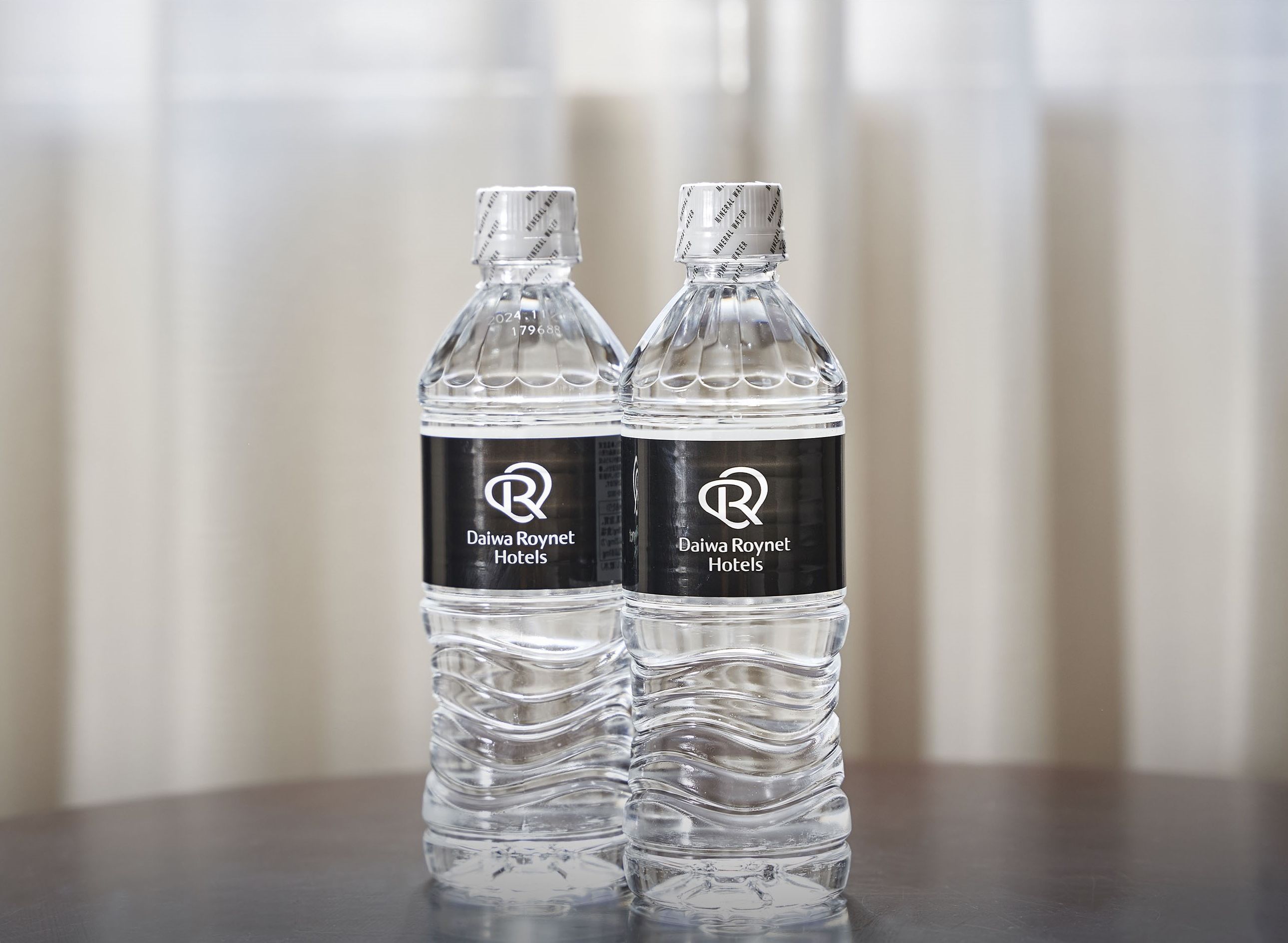 Two bottles of water with labels for Daiwa Roynet Hotels.
