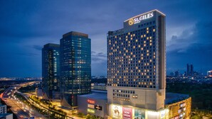 Two high-rise buildings with illuminated signage, one labeled "St. Giles Hotels" and the other with various commercial signs. - St. Giles Southkey (Johor Bahru)