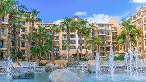 A hotel with a pool area featuring multiple water jets and lounge chairs. - Luxury resort on the beach - walking to downtown (Cabo San Lucas)