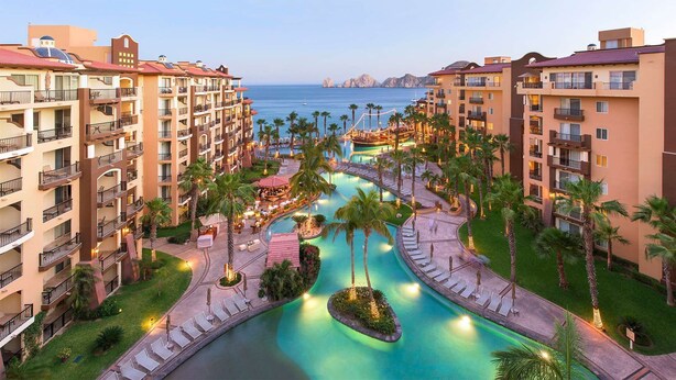 A resort with multiple buildings, a central pool area, and a view of the sea. - Luxury resort on the beach - walking to downtown (Cabo San Lucas)