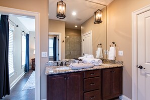 A bathroom with a double vanity, a large mirror, and a shower area visible through an open door. - ❤️Stay at Peppermint Cottage - Norton Commons -Walk eat & shop- free breakfast (Prospect)