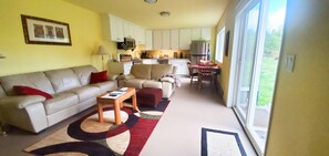 Cozy living space with a sofa, dining table, and kitchenette area.