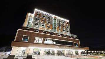 Experience the Buan Tourist Hotel's welcoming exterior, featuring a restaurant and parking area.
