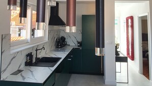 A modern kitchen with a marble countertop, green cabinets, and pendant lights. - IN Fresh - Holiday House IN Šibenik Near Center AND Beach With Parking (Šibenik)