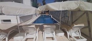 Seasonal outdoor pool, open 10:00 AM to 7:00 PM, pool umbrellas