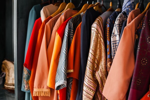 A rack of colorful scarves and shawls. - Etiuni The Forgotten Kingdom (Sevan)
