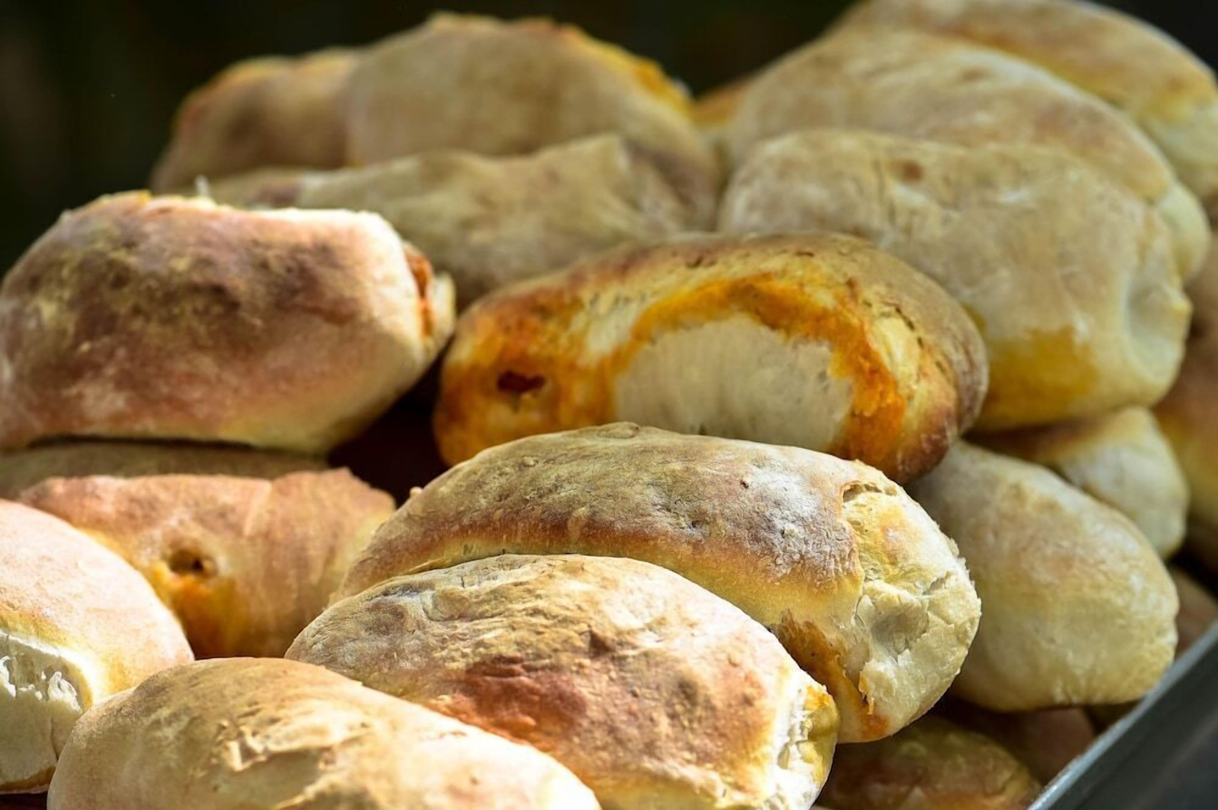 A tray of freshly baked bread rolls.