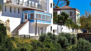 A multi-story building with balconies, a staircase, and a mix of modern and traditional architecture.