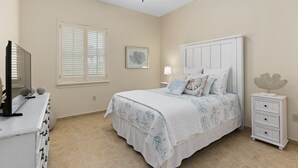 A bedroom with a bed, a nightstand, a dresser, a ceiling fan, a window with blinds, and a wall-mounted picture.