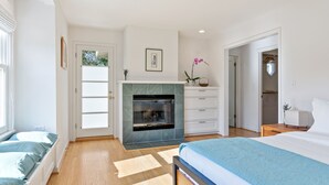 A bedroom with a bed, a fireplace, a wardrobe, and a window. - Casita Palo Alto - 2 Bed 2 Bath / Private Back Yard / WiFi (Palo Alto)