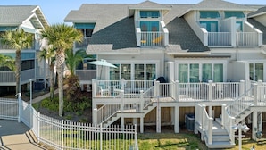 A beachfront property with multiple balconies, a covered patio, and a wooden deck. - Beachside Townhome w/ Pool |5 Decks | prime spot (Mexico Beach)