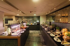 A buffet area with various food items and a counter with a menu board. - Hotel Toplice - Terme Krka (Smarjeske Toplice)