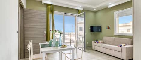 Family Apartment, 1 Bedroom, Sea Facing (Corallo House 200m From The Sea) | Living area | 21-inch flat-screen TV with cable channels