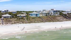 A coastal area with beachfront properties, including a prominent blue building and a large white house with a balcony. - Family Ties- Gulf Front- Perfect Panoramic Gulf Views- Private Pool- 4 Bikes (Santa Rosa Beach)