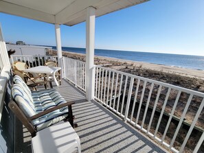 A covered outdoor seating area with a view of the beach and ocean. - OCEANFRONT!  Sweet 2 BR, 1.5 BA Condo McKinley Ave-204 Sunspot, Dewey Bch, DE (Dewey Beach)