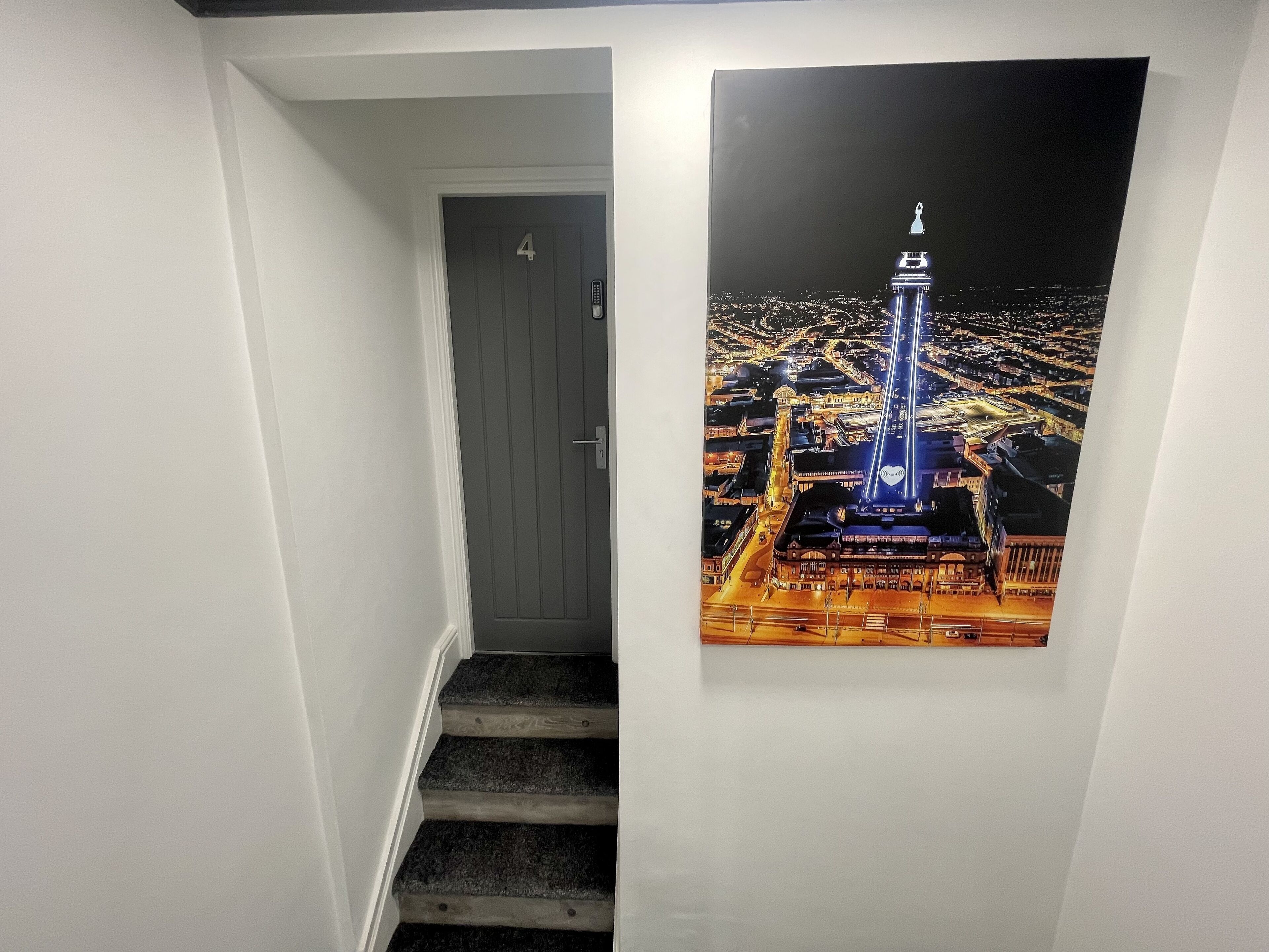 A hallway with a door marked '4' and a staircase leading to a room.