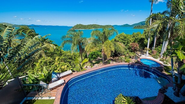 A pool with a view of a tropical beach and ocean. - Coral Sea Pearl (Shute Harbour)