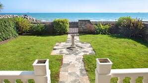 A stone pathway leading to a white balustrade overlooking a coastal view. - Weymouth Bay Apartment A (Weymouth)