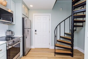 A kitchen with a stove, oven, microwave, and refrigerator. - 127th Bayside-pool-short walk 2 beach-By Park! (Ocean City)