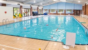 An indoor swimming pool with clear water, a tiled floor, and a roof structure. - 48 The Bay (St Margarets at Cliffe,)