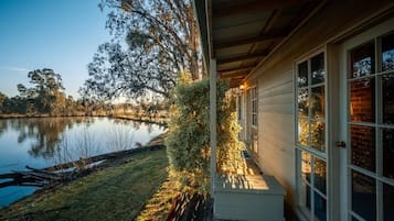 Enjoy a serene lakeside retreat with a spacious deck and cozy porch area overlooking the calm lake.