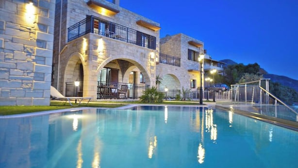 A multi-story stone building with a swimming pool, outdoor seating, and a view of the surrounding landscape. - May offer!!! Book at a discounted rate, valid until 31st May.  (Phalasarna)