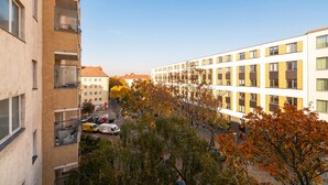 A multi-story building with a modern architectural style, featuring a mix of balconies and windows. - Recently refurbished flat, very well connected and close to Mauerpark (Berlin)